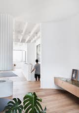 Hallway and Medium Hardwood Floor The crisp white walls contrast beautifully with the warm, timber floors, which are Sepia Grande Eterno engineered boards by Tongue N Groove.

  Photo 15 of 17 in Tama’s Tee House - A Coastal Concrete Unipod by Luigi Rosselli Architects