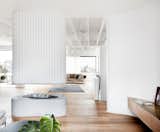 Living, Gas Burning, Sofa, Hanging, Coffee Tables, Storage, Ceiling, and Light Hardwood The crisp white walls contrast beautifully with the warm wooden floors throughout.  Living Ceiling Gas Burning Sofa Storage Photos from Tama’s Tee House - A Coastal Concrete Unipod