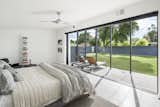 Bedroom, Bed, Ceiling Lighting, and Porcelain Tile Floor Master bedroom opened up to the patio and yard beyond  Photos