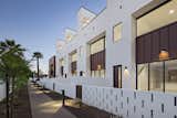 Each unit in this development is accessed by a pedestrian walkway through a private courtyard. The low, spaced concrete block wall provides a social component to the development