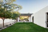 Concrete Patio, Porch, Deck, Front Yard, Trees, Shrubs, Ceiling Lighting, Concrete Floor, and Outdoor The yard doubles as the retention area for the monsoon rainstorms as well as a place for the homeowners to play  Photos from Link House