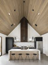Kitchen with the custom steel hood, Fireclay ceramic tile backsplash in a herringbone pattern, and Dekton counters
