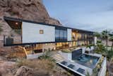 Perched on the side of Camelback Mountain in Phoenix, Arizona, a new 2nd story front addition and redesigned landscape transformed a Spanish Colonial house by embracing the desert, mountain and city views with covered patios extending out in every direction