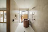 Bath Room, Marble Counter, Concrete Floor, Freestanding Tub, Marble Wall, and Open Shower Opening the master bathroom pivot door  Photo 12 of 23 in Weave by The Ranch Mine