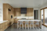 The kitchen orients itself to receive the diffused light from the left, and when the doors are open, is immediately adjacent to the outdoor grilling area