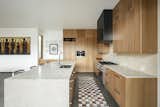 The kitchen features white oak cabinets, honed marble counters, and a custom steel clad hood 
