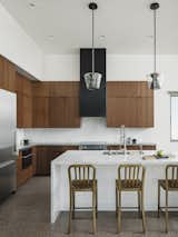 The custom, metal clad hood draws the eye up to the full height of the ceiling