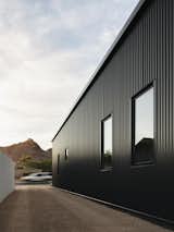A simple gravel driveway hides the garage in the rear of the house  Photo 1 of 26 in Pleats by The Ranch Mine