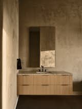 Muted bathroom with plaster walls and organic materials