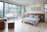 A custom walnut bed frame was designed in the master bedroom as south-facing windows maximize day light and views out. 