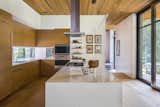 Kitchen, Range Hood, Refrigerator, Microwave, Dishwasher, Wall Oven, Light Hardwood Floor, Undermount Sink, White Cabinet, Cooktops, Quartzite Counter, Recessed Lighting, and Pendant Lighting  Photos from Wildwood