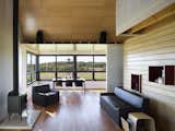 Living Room, Wood Burning Fireplace, Chair, Sofa, and Medium Hardwood Floor Yum Yum Farm in Iowa   from Dwell’s Top 10 Design Pros of 2017