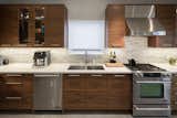 Book-matched and sequenced American Walnut wood was used in the kitchen.