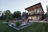 Beach Façade: A paved seating area surrounds a fire pit just beyond the house.