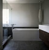 freestanding tub and floating walnut vanity at black, white and walnut master bath

[modern renovation / orange, california]