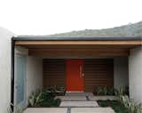 orange pivot gate + cedar at concrete / exterior courtyard entry

[midcentury modern renovation / orange county, california]  Photo 7 of 26 in Mid century modern by MYD studio, inc.