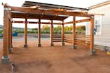 Outdoor, Field, Garden, Walkways, Vegetables, Small Patio, Porch, Deck, Wood Patio, Porch, Deck, Horizontal Fences, Wall, and Wood Fences, Wall view towards farmland beyond solar photovoltaic structure / agricultural site, San Juan Capistrano

#farm #greenbuilding  Photo 3 of 10 in Energy Lab at the Ecology Center by MYD studio, inc.