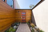 Clear cedar wraps the corner at the approach, adding warmth, texture and visual interest to the entry.