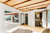 The bedroom on the main level opens to the spacious yard via a wall of sliding glass.