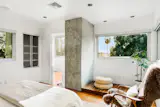 Up a short flight of stairs is another bedroom with views of the surrounding hillside.