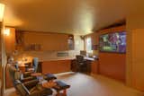 This space perfectly combines an office for two, a tv room and the guest bedroom with wall bed (behind projection screen).