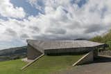 Gently rising out of the grass as the islands rise from the sea - this house is clad in sun bleached ipe decking.
