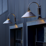 Henry with its riveted, spun-metal shade presents strong industrial aesthetics. One look will reveal the high level of craftsmanship. Bulb choices can shift the look from industrial to contemporary. 

https://www.hubbardtonforge.com/products/302712