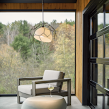The Umbra Outdoor Living Pendant features an outer shade of connected metal polygons that surround an inner frosted glass shade. The polygon shade's asymmetrical shape coupled with the slant of the glass shade, delivers a design that suggests motion. Available in your choice of Coastal Outdoor Finish. 

https://www.hubbardtonforge.com/products/362001