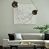 Duet Pendant - Inspired by ikebana, the Japanese art of flower arranging, this arrangement weaves together strands of steel projecting from domes finished in black. Each strand is tipped with smaller balls of steel finished in Soft Gold or Vintage Platinum. 

https://www.hubbardtonforge.com/products/136360