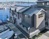 “I have a suspended water garden, with an aerator, between the house and dock. When the water lilies are in bloom, it’s fantastic,” says Dean.
The 1,300 square ft. houseboat has two levels of living space. The first is comprised of a large office with a seating area, a shop, and a fully-stocked wet bar. It also has access to a covered deck and Adirondack chairs to take in the stunning water views. The open floor plan of the upper level offers a large living room with fireplace, state-of-the-art kitchen, and master bedroom with attached bath.