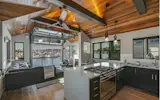 An open floor plan and careful planning allows the 1,300 sq. ft. houseboat to have a master bedroom, state-of-the-art kitchen, 2 bathrooms, an office, and bike shop—yet still feel spacious. Erlenmeyer pendants and sconces found throughout the home are by Hubbardton Forge.
“I lived there for a full year before starting the remodel, to get a feel for it. The original plan was to only make cosmetic changes—we ended up taking it down to the studs,” Dean comments. Lacey Boyer, Dean Homes’ Senior Designer, assisted with the renovation and the challenges of working on a floating residence. “We had modernized houseboats for clients before,” she says. “The challenges are lack of space and making sure the exterior is suited for the harsh marine environment. To make the process of renovation a bit easier, we decided to take it out of the water to work on it in the Ballard neighborhood shipyard.”