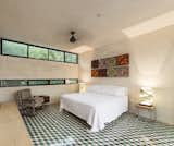 Bedroom, Bed, Table Lighting, Cement Tile Floor, Chair, and Bench Upstairs bedroom take advantage of the natural surounding from the neighborhood  Photos from Lemon Tree House