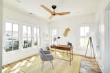 One of the bright and airy bedrooms, currently used as an office space, features a Haiku Home ceiling fan.
