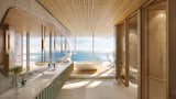 The primary bath features onyx walls, terrazzo floors, and a custom chrome  frame medicine cabinet.