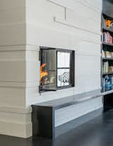Custom concrete tiles and a steel hearth complete the fireplace surround.