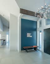 A playful neon wall installation greets guests.  Crown Major Suspension pendant and entry doors clad in steel set the tone for the interior spaces.
