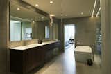 The renovated master bathroom features simple forms.