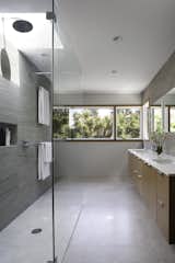 The large master bathroom is oriented towards the sunny backyard.