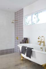 Custom Moroccan mosaic tile and brass hardware showcase the homeowner's bohemian flare to traditional midcentury style.