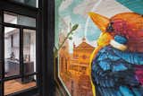 A four story courtyard is encased in all steel and glass windows for three of the walls, creating a transparent view of the interiors on each floor, and the fourth wall displays a larger than life custom mural by a local Cincinnati artist highlighting scenes from the local downtown market.