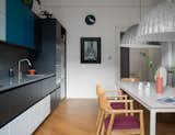 Kitchen, Engineered Quartz Counter, Undermount Sink, Wall Oven, Colorful Cabinet, Refrigerator, Microwave, Stone Slab Backsplashe, Pendant Lighting, and Medium Hardwood Floor  Photo 5 of 24 in Coates Place by Mr Buckley Interiors