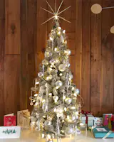 I like the twin table top monochromatic icicle tree against the rich wood tone in the house. 