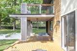 Outdoor, Wood Fences, Wall, Horizontal Fences, Wall, Large Patio, Porch, Deck, Pavers Patio, Porch, Deck, Wood Patio, Porch, Deck, Landscape Lighting, and Back Yard Exterior View of Brush Hill Residence  Photo 19 of 19 in Brush Hill Residence a New home in Milton by KNK studios