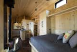 This tiny house is fully usable even when the Queen-sized bed is deployed.  Photo 17 of 23 in SaltBox Tiny House by Extraordinary Structures