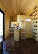 This tiny house doesn't have a loft for sleeping--that happens on the ground floor. This loft is a reading nook that's lined in thick felt.