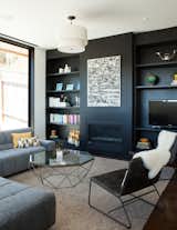 the family room with fireplace wall and shelving painted almost-black
