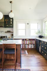 a built-in bookcase conveniently holds a large cookbook collection