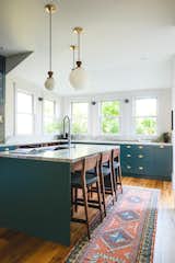 the island with stools for guests to hang out