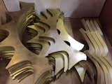 These brass fins await assembly by hand on the Proteus Pendant.