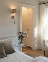 The Duchess Sconce adds a little frill to this simple bedroom.